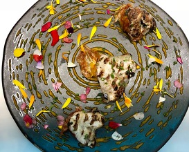Kokotxas on their own wavelength. Grilled hake chins on a coconut and turmeric spiral with “pearl” and squid crisps 