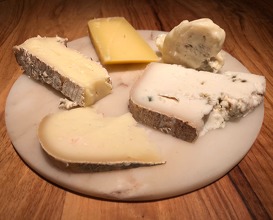 Selection of cheese served with two wines 