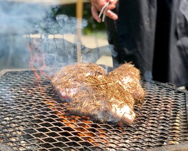 Menapi (pork shoulder) being prepared, presented and cooked on the open fire 