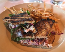 Grilled pork loin sandwich with spicy coleslaw and fried shoestring potatoes