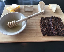Selection of cheeses with flat bread and honey