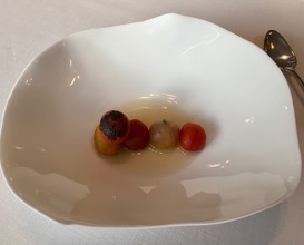 Tomatoes, aromatic herbs, and caper broth