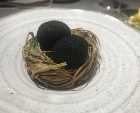 A small egg coated in ash, sauce made from dried trout and pickled marigold
