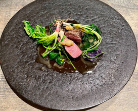 slivers of meat from a tsukinowa brown bear, lean at the end of its hibernation, encased in a nikogori gelee prepared from a consommé of the same meat